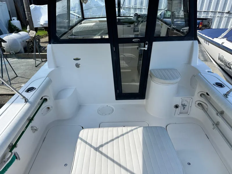 Slide: The Image of 2004 Trophy 2359 Hardtop boat interior with seating and storage compartments. - 46