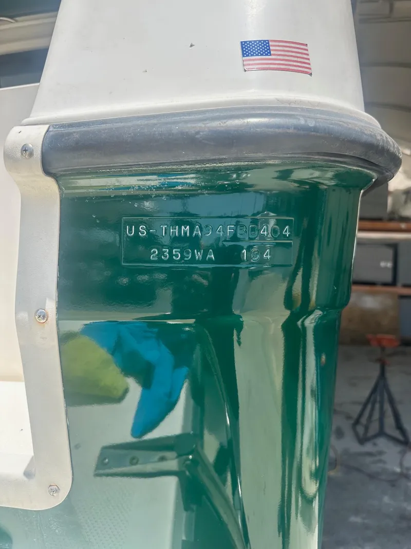 Slide: The Image of 2004 Trophy 2359 Hardtop boat on display at a marina, American flag in background. - 6