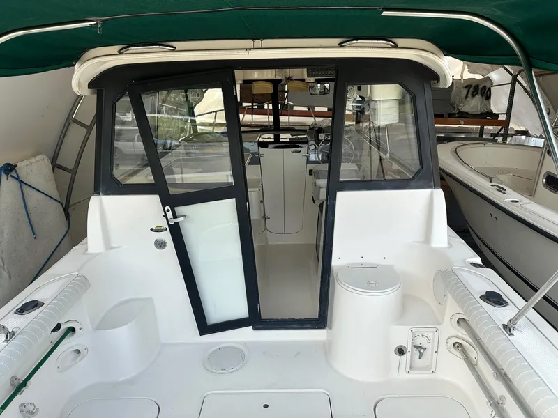Slide: The Image of 2004 Trophy 2359 Hardtop boat named "Gusto" for sale at a marina. - 7