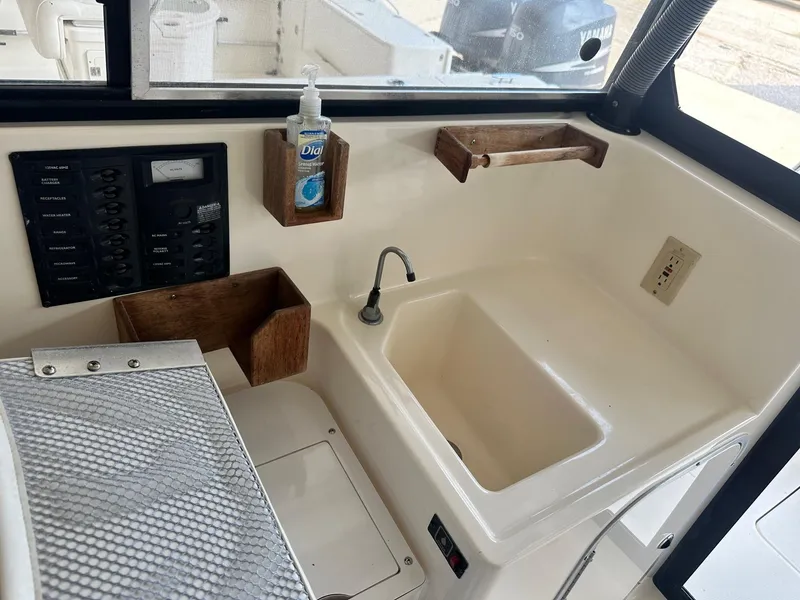 Slide: The Image of 2004 Trophy 2359 Hardtop boat on display in a marina. - 9