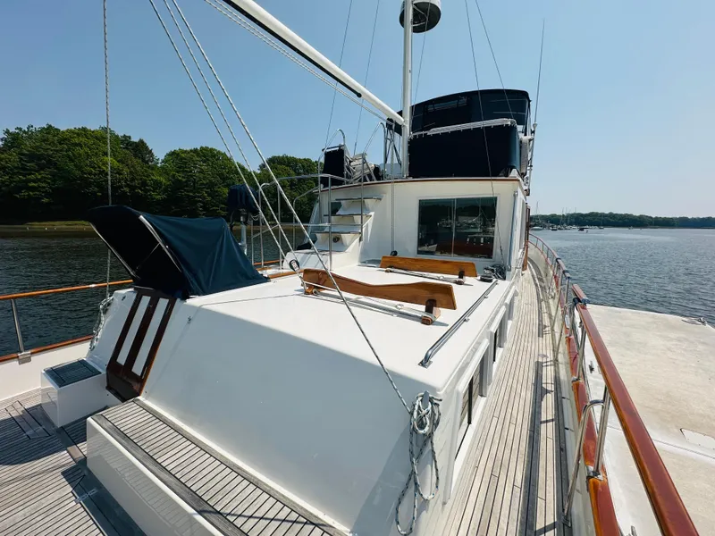 Slide: The Image of 1998 Grand Banks 49 Classic yacht docked by a serene waterfront. - 12