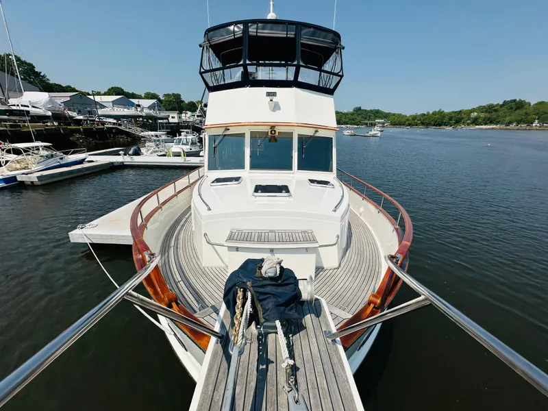 Slide: The Image of 1998 Grand Banks 49 Classic yacht docked in a serene marina setting. - 14
