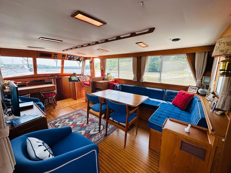 Slide: The Image of Interior of 1998 Grand Banks 49 Classic yacht with elegant wood finish and blue seating. - 17