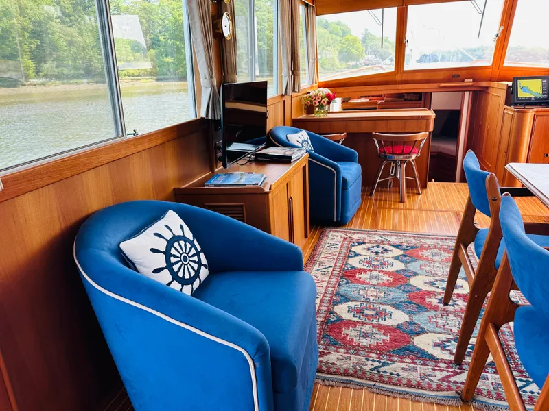 Slide: The Image of Interior of 1998 Grand Banks 49 Classic yacht with blue chairs and nautical decor. - 19