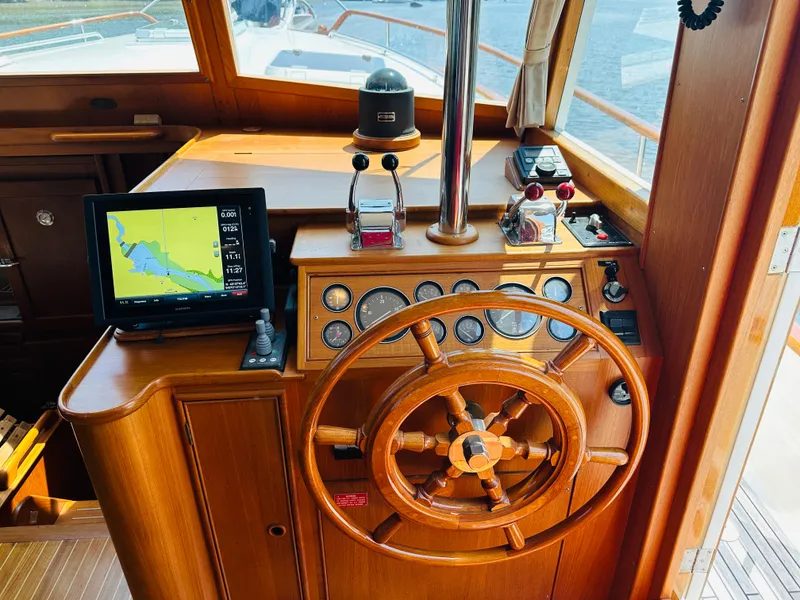 Slide: The Image of Helm of 1998 Grand Banks 49 Classic yacht with wooden wheel and navigation equipment. - 30