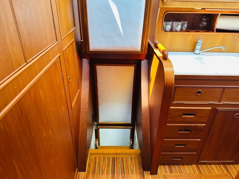 Slide: The Image of Interior of 1998 Grand Banks 49 Classic yacht with wooden cabinetry and sink. - 47