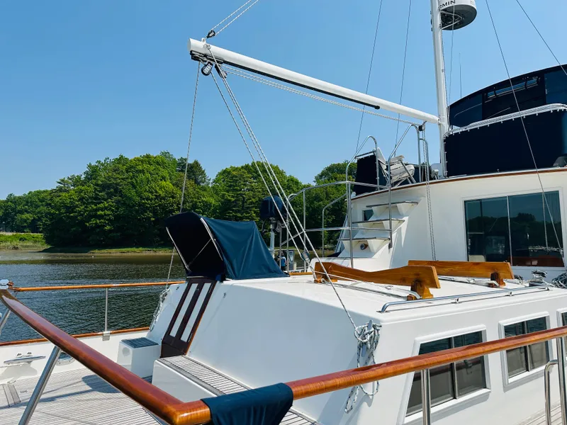 Slide: The Image of 1998 Grand Banks 49 Classic yacht docked by a scenic riverside. - 8