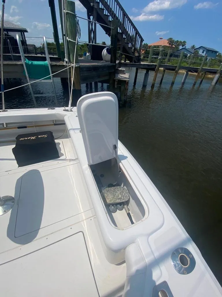Slide: The Image of 1970 Bertram 31 Bahia Mar boat deck with open storage compartment by a dock. - 11