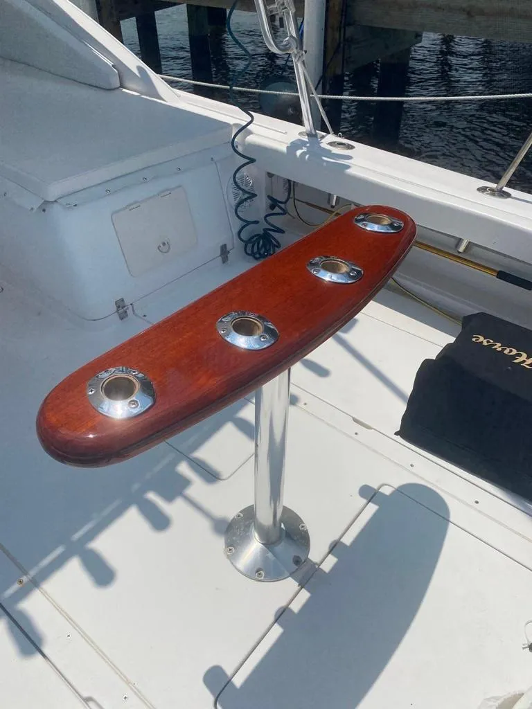 Slide: The Image of 1970 Bertram 31 Bahia Mar boat with wooden rod holder on deck. - 14