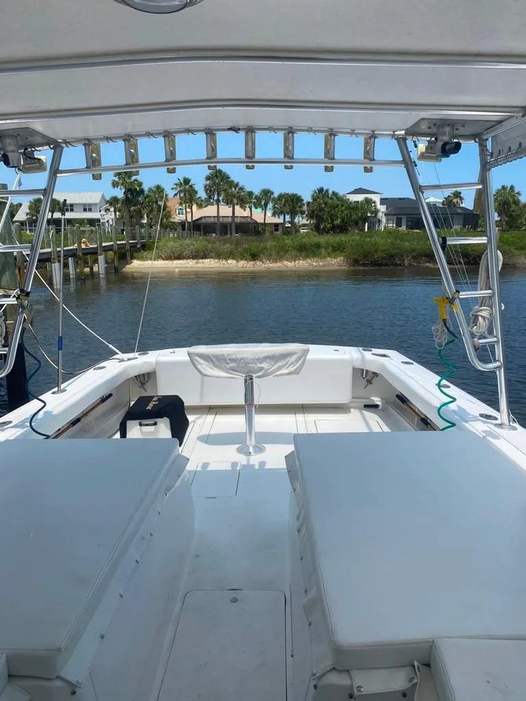 Slide: The Image of 1970 Bertram 31 Bahia Mar boat interior with waterfront view and palm trees. - 16