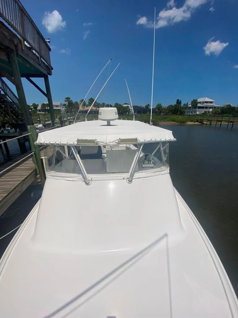 Slide: The Image of 1970 Bertram 31 Bahia Mar boat docked under clear blue sky. - 21
