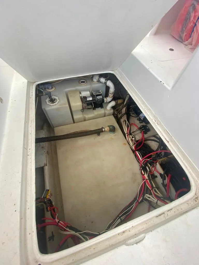 Slide: The Image of 1970 Bertram 31 Bahia Mar engine compartment with wiring and components visible. - 25