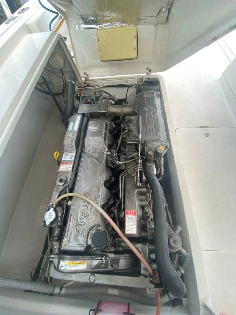 Slide: The Image of Engine compartment of a 1970 Bertram 31 Bahia Mar boat, showcasing detailed mechanical components. - 26