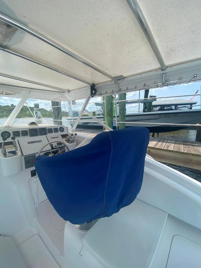 Slide: The Image of 1970 Bertram 31 Bahia Mar boat interior with blue captain's chair and control panel. - 29