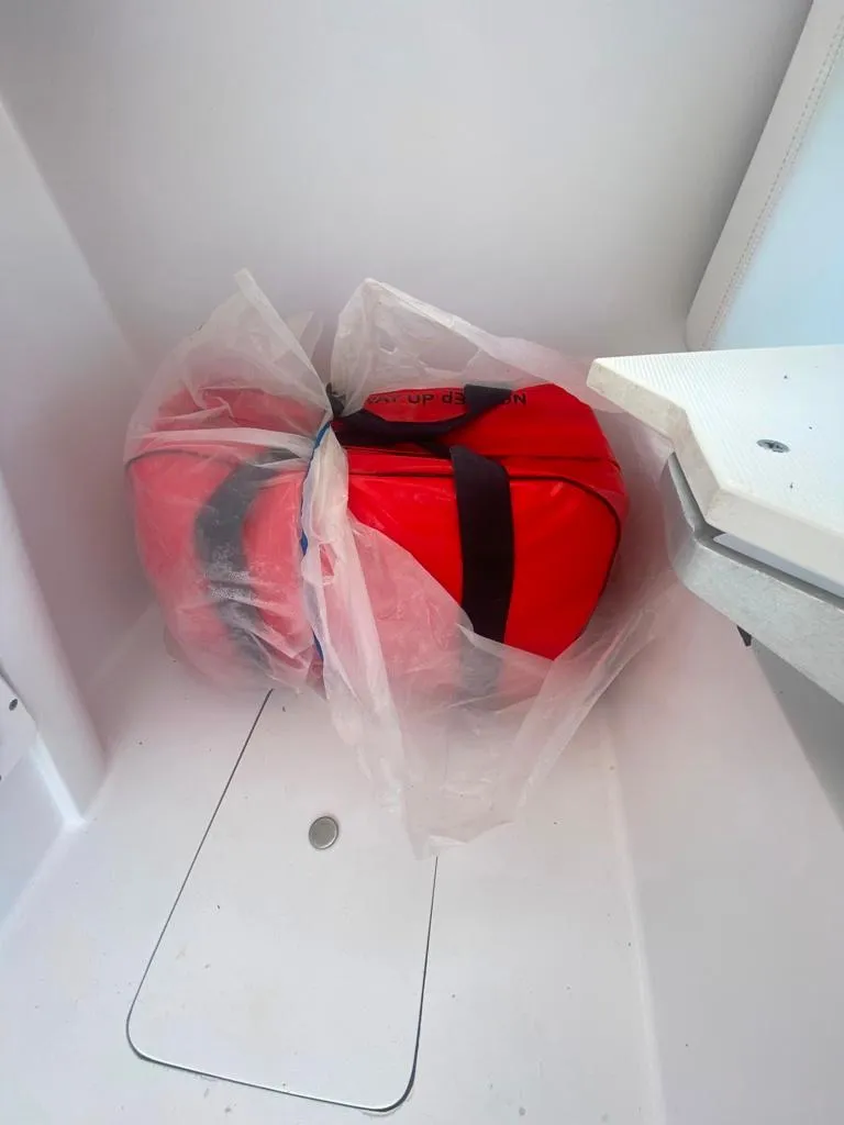Slide: The Image of Red life jackets in plastic bag on 1970 Bertram 31 Bahia Mar boat. - 30