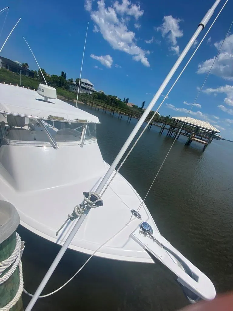 Slide: The Image of 1970 Bertram 31 Bahia Mar boat docked on a sunny day with blue skies. - 6