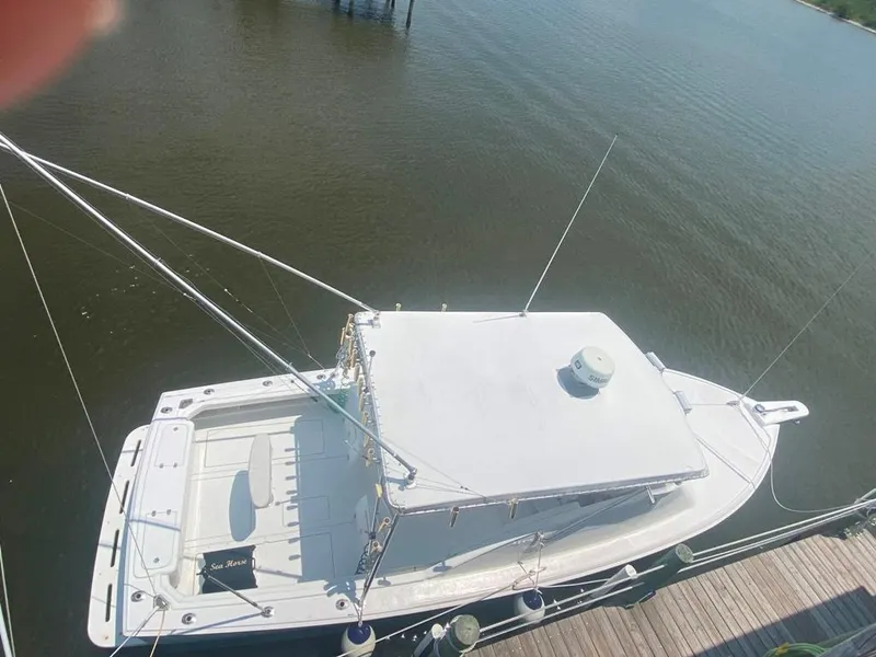 Slide: The Image of 1970 Bertram 31 Bahia Mar boat docked on calm water, aerial view. - 8