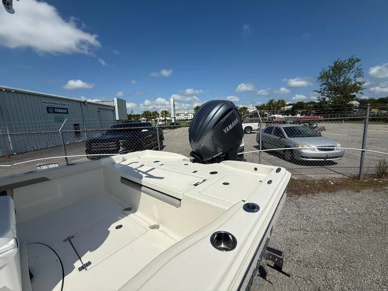 Slide: The Image of Avenger AV26 boat, 2025 model, with Yamaha outboard motor in a parking lot. - 3