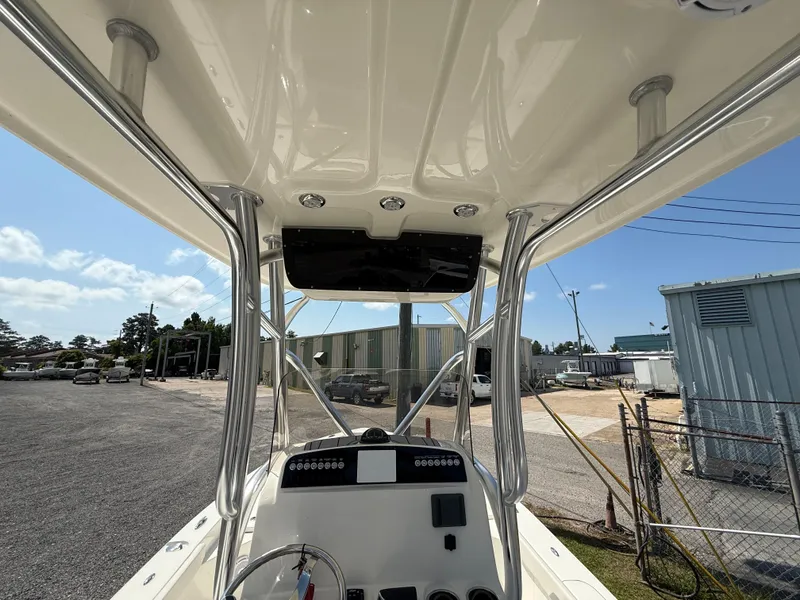 Slide: The Image of 2025 Avenger AV26 boat console with T-top, parked outdoors under a clear sky. - 5