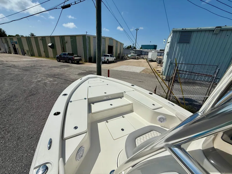Slide: The Image of 2025 Avenger AV26 boat in industrial area, showcasing bow and storage compartments. - 7