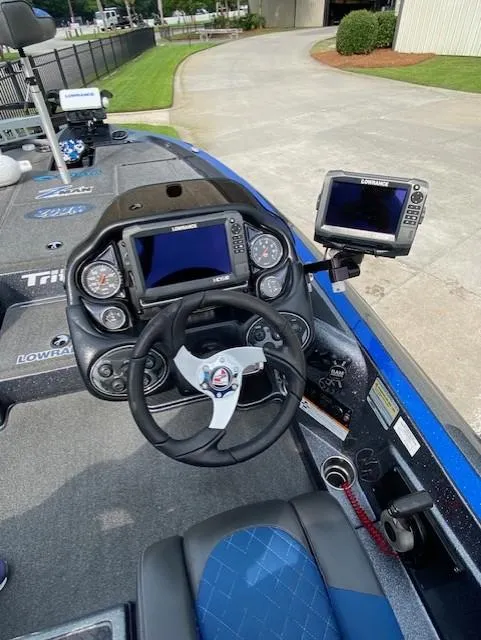 Slide: The Image of 2016 Triton 179 TrX boat cockpit with steering wheel and navigation screens. - 5