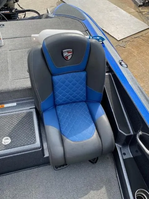 Slide: The Image of 2016 Triton 179 TrX boat seat with blue and gray upholstery, featuring a quilted design. - 7