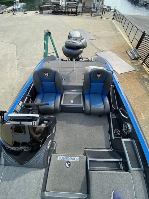 Slide: The Image of 2016 Triton 179 TrX boat interior with blue seats and fishing equipment. - 8