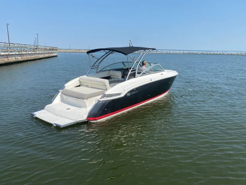 Slide: The Image of 2014 Cobalt 276 boat with canopy on calm water near a dock. - 3