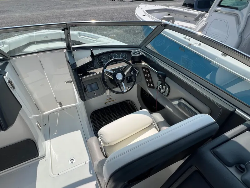 Slide: The Image of 2014 Cobalt 276 boat cockpit with steering wheel and dashboard controls. - 7