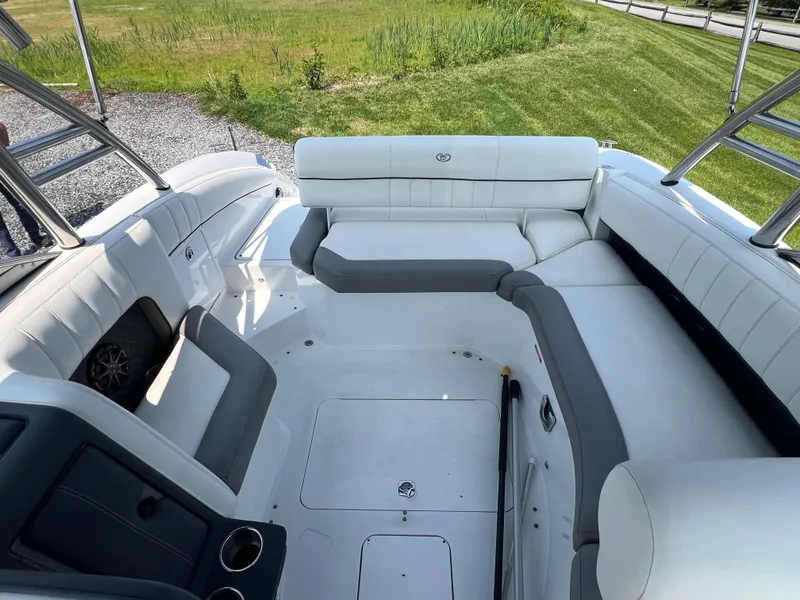 Slide: The Image of 2014 Cobalt 276 boat interior with white seating and cup holders. - 8