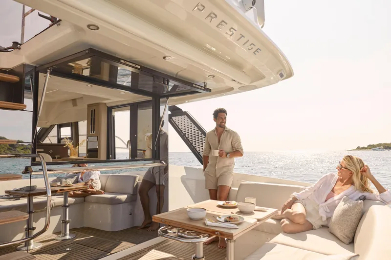 Slide: The Image of Luxury yacht Prestige F4.3, 2026 model, with people relaxing on deck by the sea. - 13