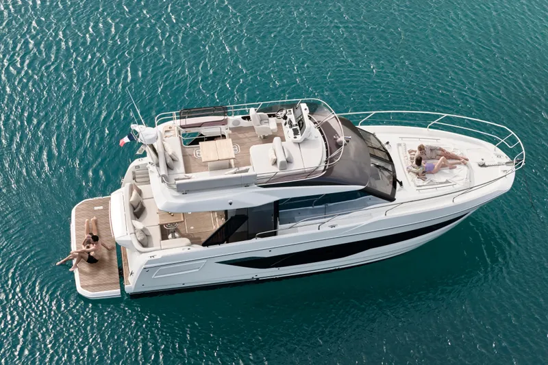 Slide: The Image of Luxury Prestige F4.3 yacht cruising on clear blue waters, 2026 model. - 2