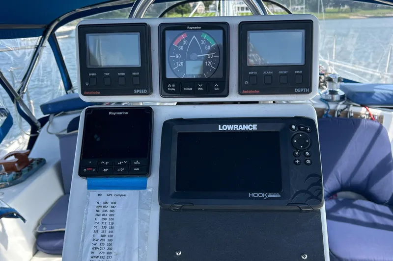 Slide: The Image of Cockpit navigation instruments on a 1998 Catalina 36MKII sailboat, featuring Raymarine and Lowrance displays. - 11