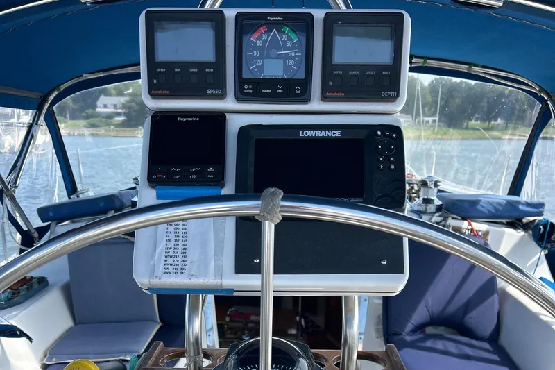 Slide: The Image of Cockpit of 1998 Catalina 36MKII sailboat with navigation instruments and steering wheel. - 12