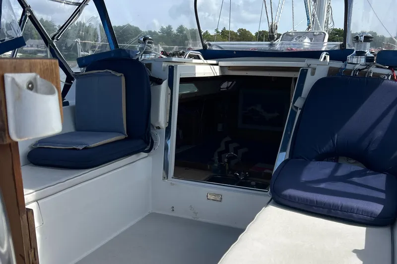 Slide: The Image of 1998 Catalina 36MKII sailboat cockpit with blue cushions and open cabin entrance. - 15
