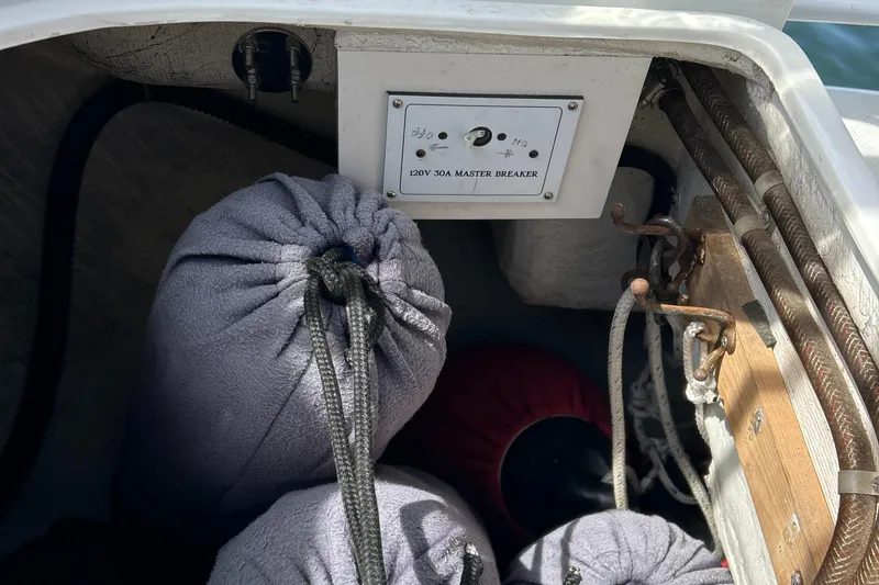 Slide: The Image of Storage compartment of 1998 Catalina 36MKII sailboat with bags and electrical panel. - 16