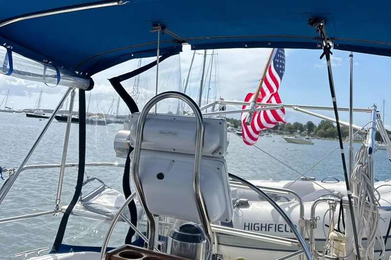 Slide: The Image of Cockpit view of 1998 Catalina 36MKII sailboat with American flag and marina backdrop. - 20