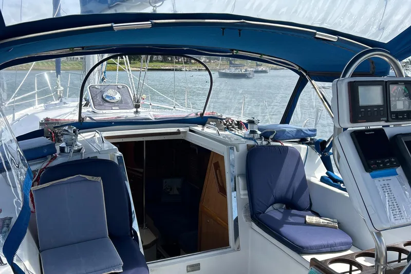 Slide: The Image of 1998 Catalina 36MKII sailboat cockpit with blue seating and navigation equipment. - 21