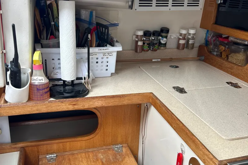 Slide: The Image of Compact kitchen area in a 1998 Catalina 36MKII sailboat with spices and utensils. - 26
