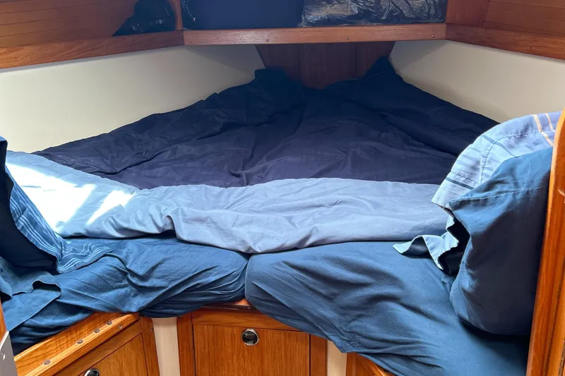 Slide: The Image of Cozy cabin interior of 1998 Catalina 36MKII sailboat with blue bedding. - 27