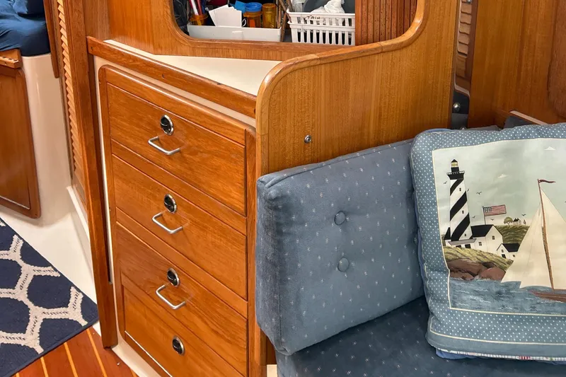 Slide: The Image of Interior of a 1998 Catalina 36MKII sailboat with wooden cabinetry and nautical-themed cushion. - 30