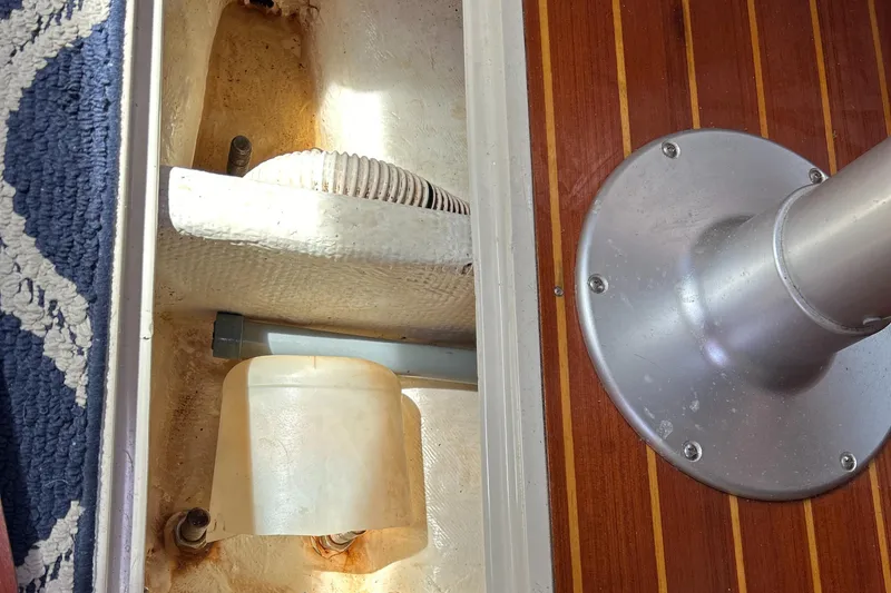 Slide: The Image of Interior view of a 1998 Catalina 36MKII sailboat, showing a compartment and wooden flooring. - 34