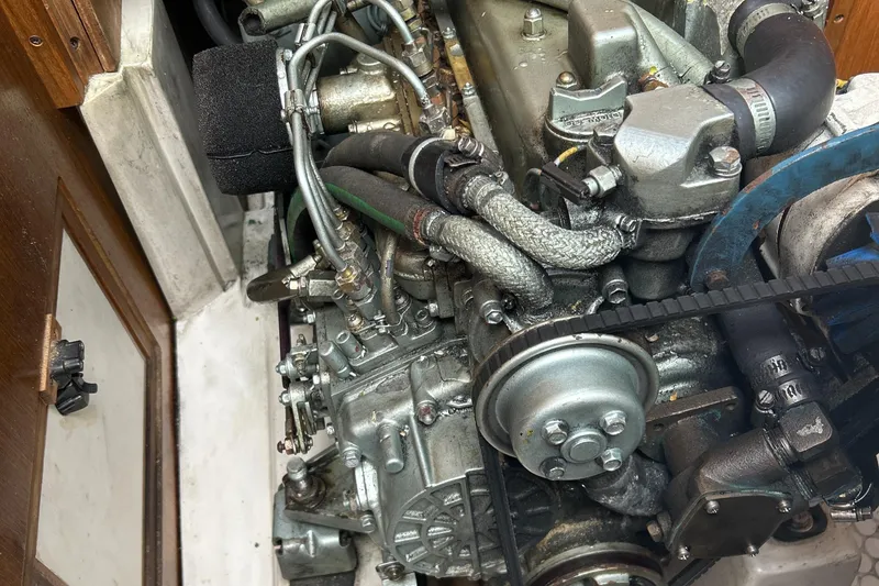 Slide: The Image of Engine of a 1998 Catalina 36MKII sailboat, showcasing mechanical components and hoses. - 35