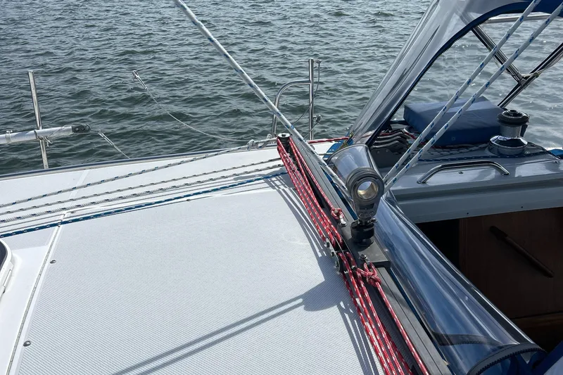 Slide: The Image of Sailboat deck of 1998 Catalina 36MKII with ropes and winch, on calm water. - 6