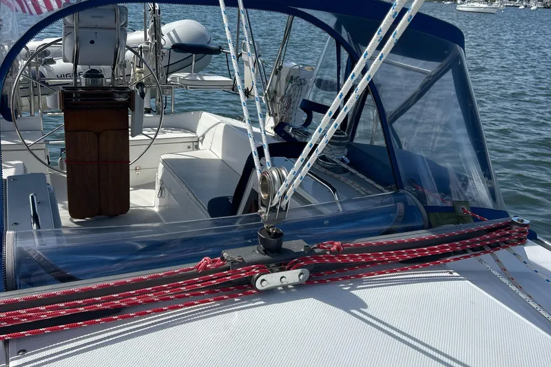 Slide: The Image of Cockpit of a 1998 Catalina 36MKII sailboat with blue canopy and red ropes. - 8