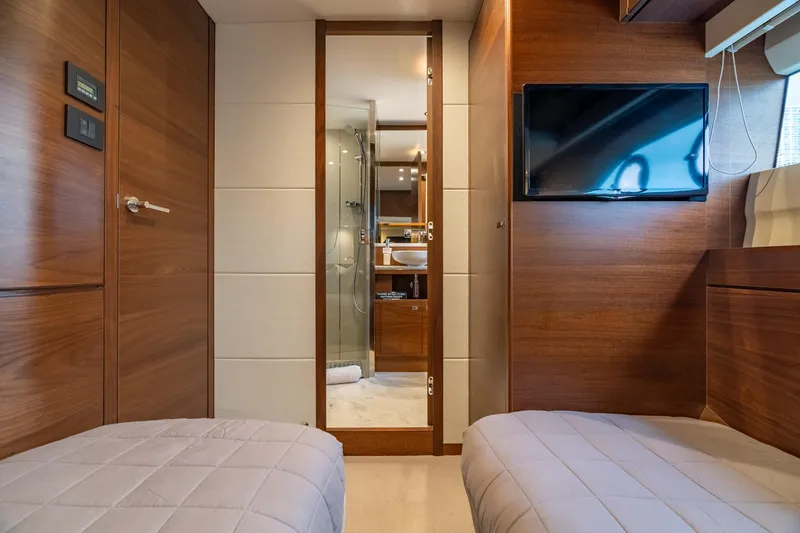 Slide: The Image of Luxurious 2019 Princess F70 yacht cabin with twin beds, TV, and ensuite bathroom. - 13