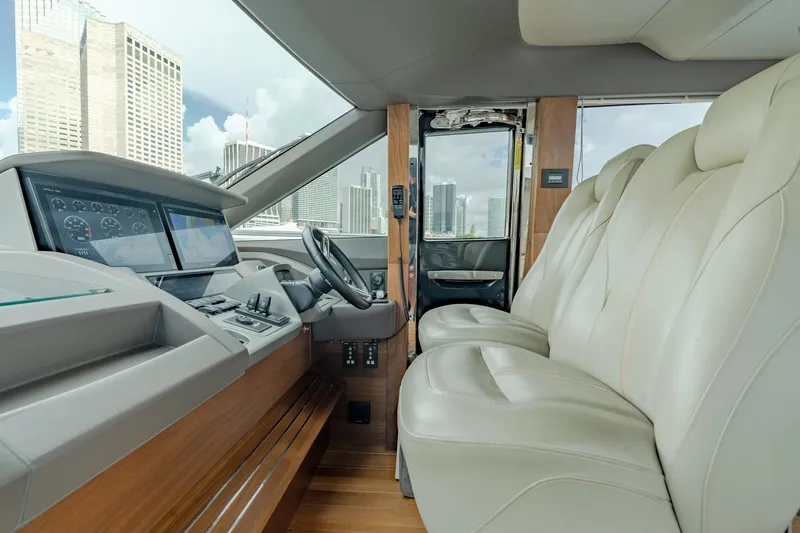 Slide: The Image of Luxurious 2019 Princess F70 yacht interior with leather seating and modern dashboard. - 17
