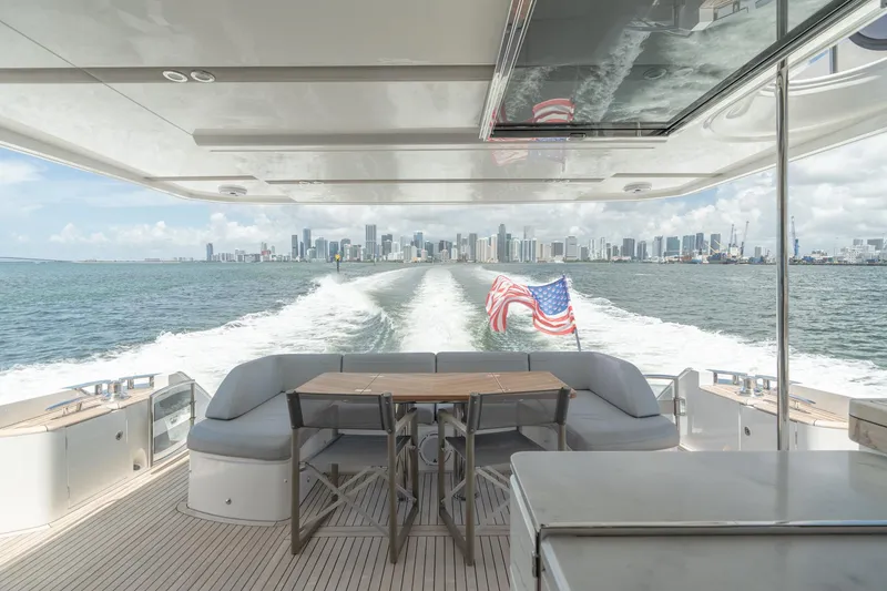 Slide: The Image of Luxurious 2019 Princess F70 yacht cruising with city skyline view and American flag. - 18