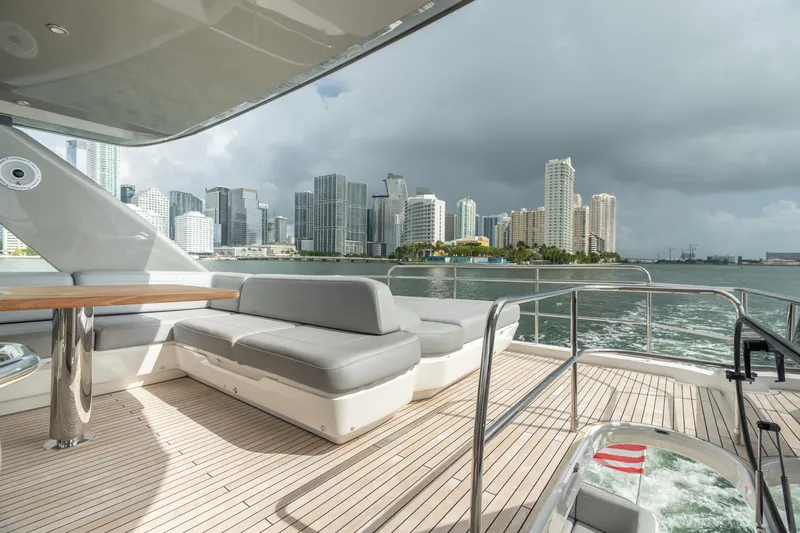 Slide: The Image of Luxurious 2019 Princess F70 yacht with city skyline view, featuring spacious deck seating. - 22