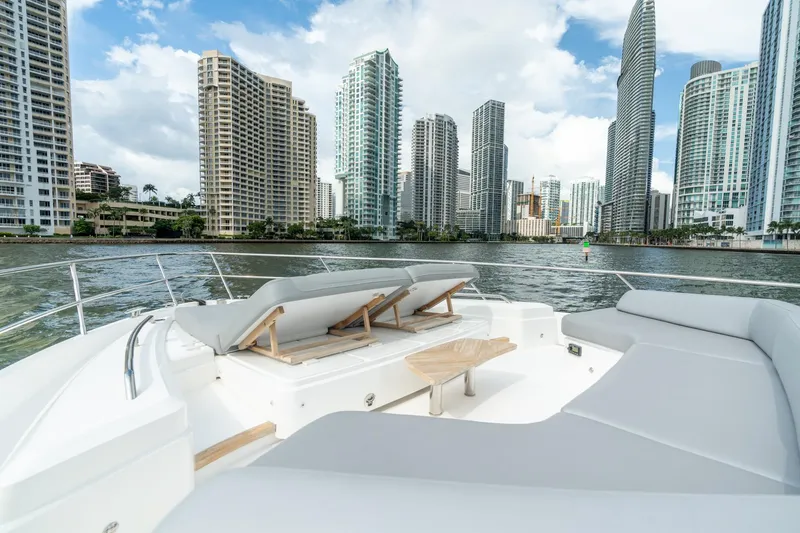 Slide: The Image of Luxurious 2019 Princess F70 yacht with city skyline view, featuring spacious deck seating. - 24